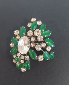 This vintage green and clear crystal brooch is not marked. The Mantessa tag was on this brooch when purchased. Jeweled Evening Costume Jewelry Brooches, Green Brooch For Party, Green Brooch Jewelry For Evening, Vintage Green Brooch For Formal Occasion, Vintage Green Brooches For Formal Occasions, Green Jeweled Brooches As Gift, Antique Green Brooches For Wedding, Green Vintage Brooch For Formal Occasions, Green Evening Brooch Jewelry