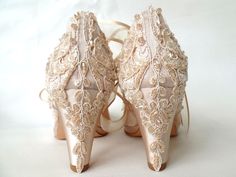 a pair of high heeled shoes with lace on them