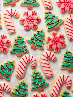 decorated christmas cookies are displayed on a table