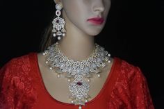 About the Jewellery  Most beautiful grand wedding  choker .stunning  shine of stone.give this a adorable  looks . Perfect  for indian bride . This choker come with a beautiful   earings  Details & Specifications Metal-Brass, silver Finish-diamond finishesd Polish-gold polish Stones-triple cut Diamond  Beeds-pearls Size- Earrings -pressing For-Woman Occasion-Birthday, party, wedding, Reception,angejment Jewellery care Here are some of the best ways to care for your artificial jewellery: Keep it d Bollywood Style Bridal Necklace With American Diamond, Elegant Heavy American Diamond Bridal Necklace, Festive American Diamond Cutdana Bridal Necklace, Luxury Bollywood Style Choker, American Diamond Stone-set Necklace For Weddings, Party Wedding Reception, Tea Wedding Favors, Grand Wedding, Diamond Choker Necklace