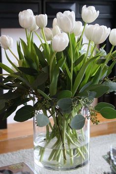 a vase filled with white flowers on top of a table