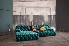 a woman sitting on top of a blue couch