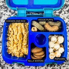 a blue lunch box with compartments filled with food