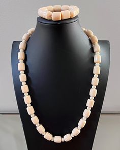 This is a traditional West African off-white beaded necklace. These jewelry pieces are unisex and are designed to be worn by adults Beads are NOT plastic. Agate beads Length ( from neck to chest): 13.5 inches *** Each Necklace comes with a matching bracelet These beaded jewelry is an integral part of West African culture. Traditionally it is worn by Royalty, Chiefs, and those who are part of the Royal households among many kingdoms in West Africa. It is also worn by brides and grooms during thei White Jewelry With Oval Wooden Beads, Adjustable Cream Beaded Necklaces With Large Beads, Classic White Handmade Beaded Necklaces, Classic Handmade White Beaded Necklaces, Traditional Beaded Beige Jewelry, Classic Adjustable Beaded Necklace With Polished Beads, Adjustable Cream Jewelry With Large Beads, Cream Single Strand Jewelry With Round Beads, Cream Hand-strung Round Bead Jewelry