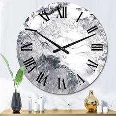 a clock with roman numerals is on the wall next to some vases