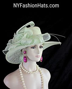 Women's Mint Green Sinamay Straw Large Abstract Brim Couture Designer Hat. This Beautiful Hat Is Embellished With A Decorative Large Sinamay Straw Bow. This Formal Statement Hat Wedding Headpiece Can Be Worn In Different Positions. This Elegant Soft Pastel Colored Hat Will Make A Fashion Statement. This ladies bespoke couture formal designer wedding fascinator hat is appropriate to wear for horse races, The Kentucky Derby, The Dubai World Cup, The Royal Ascot, The Melbourne Cup, Belmont Stakes, Fitted Brimmed Mini Hat For Wedding, Fitted Wide Brim Mini Hat For Weddings, Summer Wedding Fitted Costume Hats And Headpieces, Fitted Summer Wedding Hats And Headpieces, Fitted Short Brim Hat For Wedding, Brimmed Mini Hat Fitted For Wedding, Adjustable Green Mini Hat For Wedding, Fitted Wedding Hat With Short Brim, Adjustable Green Costume Hats And Headpieces For Wedding