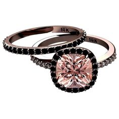 two engagement rings with black diamonds and a pink diamond in the center on a white background