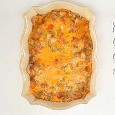 a casserole dish with cheese and meat in it on a white surface,