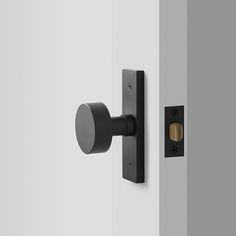 an open door with a black handle on it and a round knob in the middle