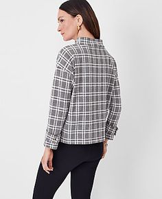 Elevate your wardrobe with the Ann Taylor Petite Plaid Button Tab Mock Neck Top, a perfect blend of style and comfort. This top is designed specifically for petite frames, ensuring a flattering fit for smaller proportions.

- **Size:** Petite 2XS
- **Color:** Black
- **Material:** 62% Cotton, 37% Polyester, 1% Spandex
- **Gender:** Female
- **Fit:** Relaxed
- **Length:** 22 3/4" long
- **Sleeve Type:** Long sleeves with button tab cuffs
- **Neckline:** Mock neck
- **Care Instructions:** Machine Fall Tops With Stand Collar And Button Closure, Casual Tops With Stand Collar For Work, Versatile Long Sleeve Mock Neck Top For Work, Classic Long Sleeve Mock Neck Top For Work, Winter Business Casual Tops With Buttons, Classic Stand Collar Top For Work, Classic Stand Collar Tops For Work, Casual Tops With Stand Collar And Button Cuffs, Fall Business Casual Tops