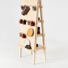 a wooden shelf with cups and mugs mounted to it's sides on the wall