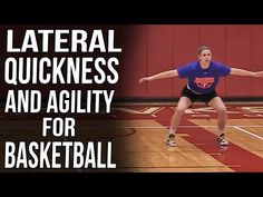 a woman in blue shirt and black shorts playing with a ball on basketball court next to red wall