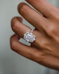 a woman's hand with a diamond ring on it