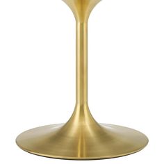 a gold pedestal table with a glass top and metal base on an isolated white background