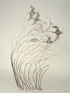 a sculpture made out of branches with birds on it