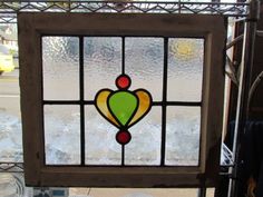 a stained glass window in the corner of a building