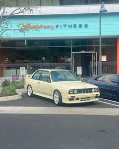 two cars parked in front of a building