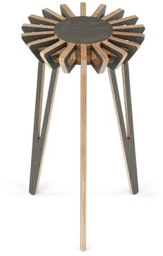 a wooden stool with an intricate design on the top