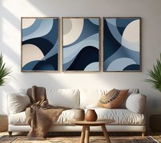 a living room with two paintings on the wall