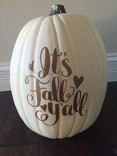 a white pumpkin with the words it's fall y'all painted on it