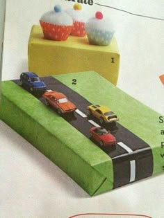 an advertisement for cupcakes with cars driving on the road in front of them