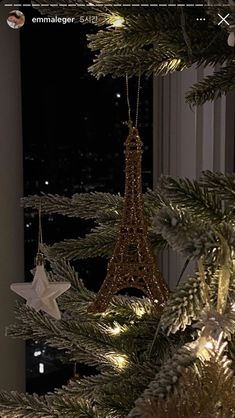 the eiffel tower ornament is hanging from a christmas tree