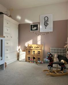 a baby's room is decorated in neutral colors and features rocking horse, crib, toy chest, dresser, and bed