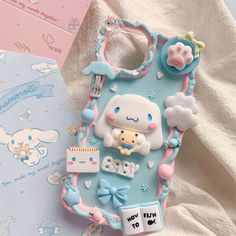 a cell phone case with an image of a baby doll and other items on it