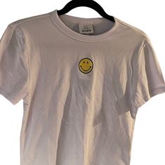 Nwt Smiley Face Crop T-Shirt Size Medium Basic Yellow T-shirt With Graphic Print, Trendy Yellow Crew Neck T-shirt, Summer Streetwear Tops With Smiley Face, Summer Smiley Face Tops For Streetwear, Trendy Short Sleeve Top With Smiley Face, White Graphic Tee With Smiley Face, White Smiley Face Graphic Tee, Spring Crew Neck Top With Smiley Face, White Relaxed Fit Top With Smiley Face