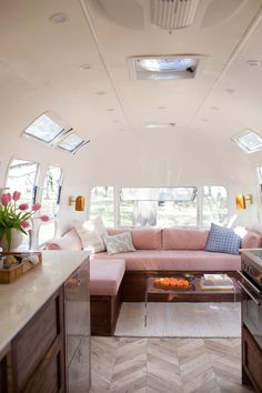 a living area with couch, coffee table and kitchen