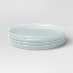 four white plates stacked on top of each other