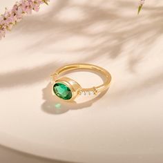 Elevate your promise with our Gold Oval Emerald Framed Promise Ring. A delicate oval emerald set in a delicate frame symbolizes enduring love. Crafted from polished 14-karat gold, this ring combines sophistication and sensuality, a timeless expression of devotion. - Made in 14k solid gold - Decorated with lab-created emerald - Band Width: 1.59 mm / 0.06 inches - Top Width: 10.0x8.0 mm / 0.39x0.31 inches - Thickness: 1.44 mm / 0.05 inches - This product comes with an iconic Norm Jewels gift box Fine Jewelry Emerald Oval Cabochon Ring For May Birthstone, Elegant Formal Ring With May Birthstone, Oval Emerald Diamond Ring With Bezel Setting, Elegant Green Birthstone Ring For Formal Occasions, Elegant Formal May Birthstone Ring, Elegant Emerald Ring For May Birthstone And Formal Events, Elegant Emerald Ring With Oval Cabochon, Formal Oval Cabochon Emerald Ring For May, Elegant Formal Emerald Ring For May Birthstone