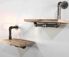 two wooden shelves with metal pipe handles and lights on each shelf, one is turned upside down