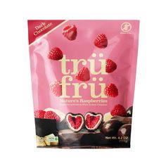 a bag of truf fruit with raspberries and chocolates on the side