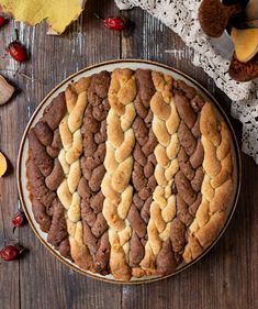 a cake on a wooden table surrounded by autumn leaves