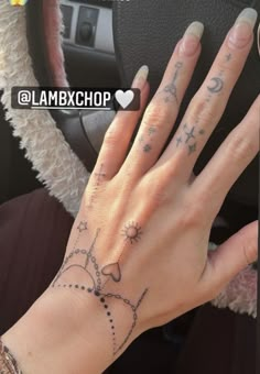 a woman's hand with tattoos on it