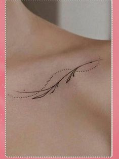 the back of a woman's shoulder with an arrow tattoo