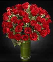 a bouquet of red roses in a green vase