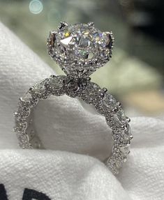 a diamond ring sitting on top of a white towel