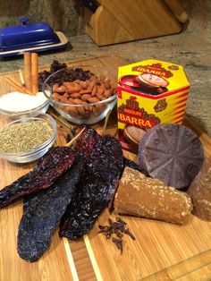 an assortment of food on a cutting board with nuts, raisins and other ingredients