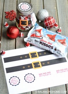 some candy is sitting on top of a piece of paper next to christmas decorations and other items