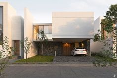 a white car parked in front of a house