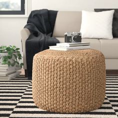 a living room with a white couch and black and white rug