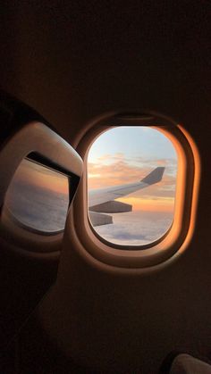 an airplane window looking out at the ocean and clouds from it's seat area