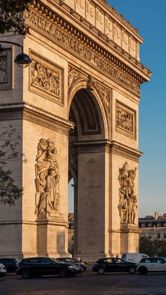 cars are parked in front of the arc de trio triumphe, which is also known as the arch of triumph