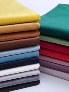 many different colored sheets stacked on top of each other