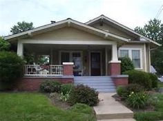 a small house with steps leading up to the front door