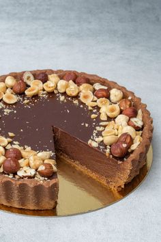 there is a chocolate cake with nuts on it