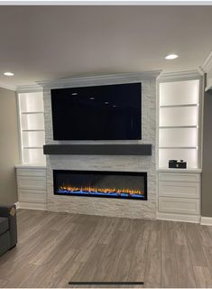 a living room with a fireplace and entertainment center