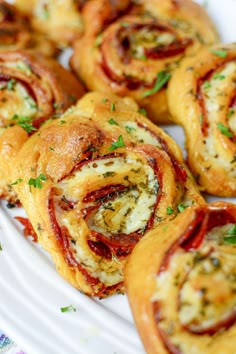 small pastries on a white plate with parsley sprinkled around the edges